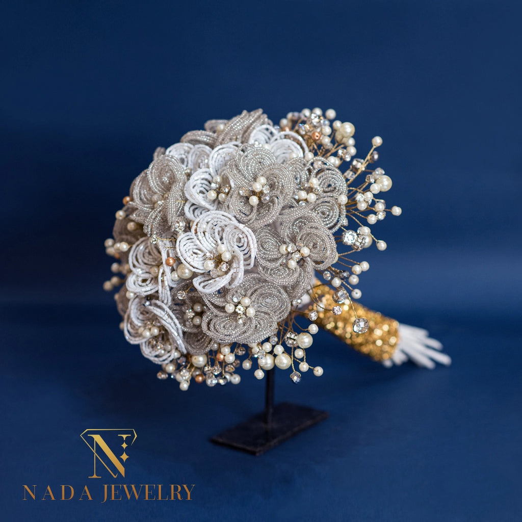 Elegant jewelry piece with floral design on a stand against a dark blue background, featuring the Nada Jewelry logo.