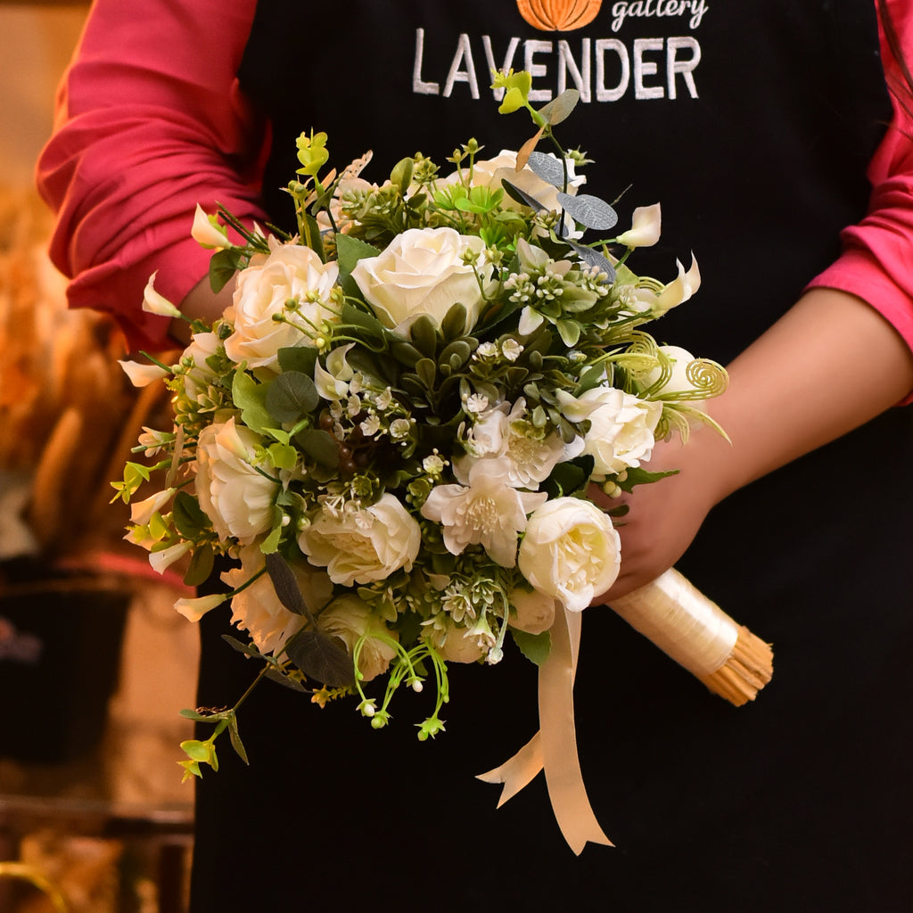White roses .Small peony .Green leaves .Baby calla and.White small gerb