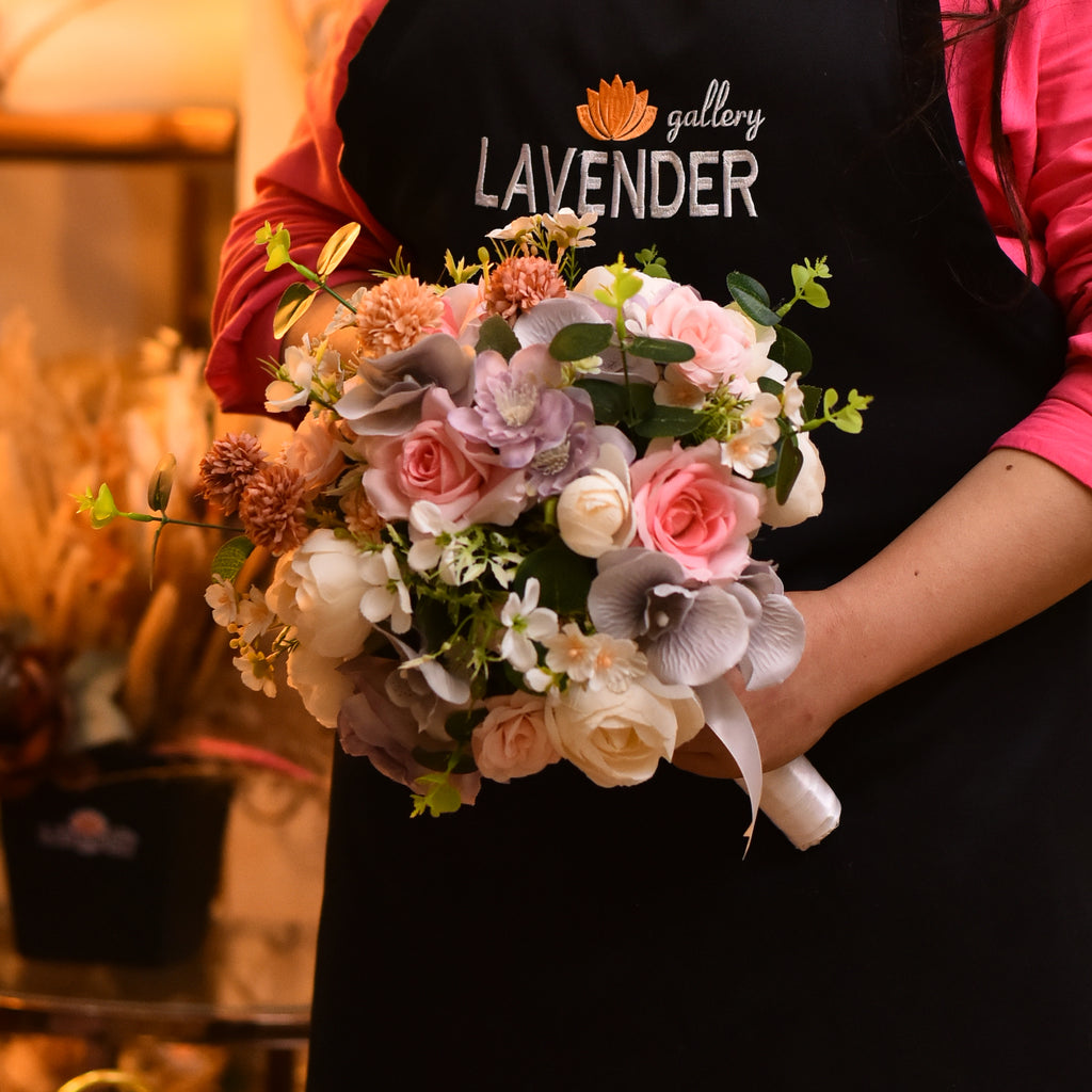 Pink and purple roses .Small Peony.Small pink roses.Small semon carnation .Purple small gerbera Gray orchid.Yasmen flower and Green kelptos 