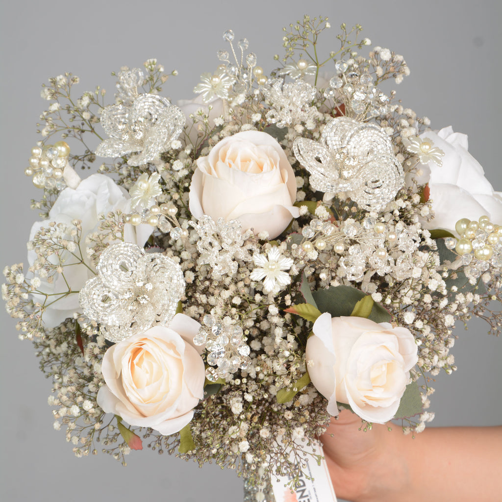 Artificial white roses .Natural white gypsophila. Hand made crystal Flower.Hand made Crystal and pearl 
Plastic white flower and crystal flower
