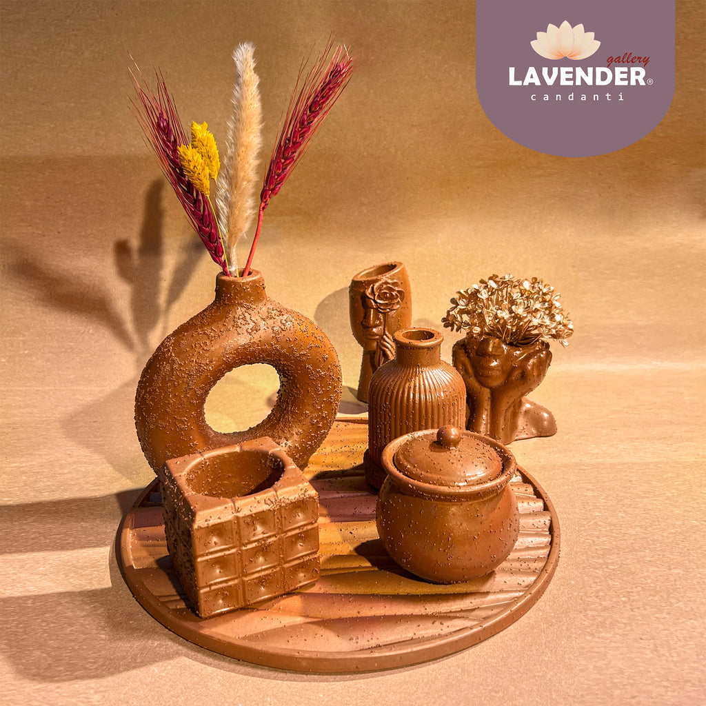 Collection of brown ceramic vases and containers on a wooden tray 