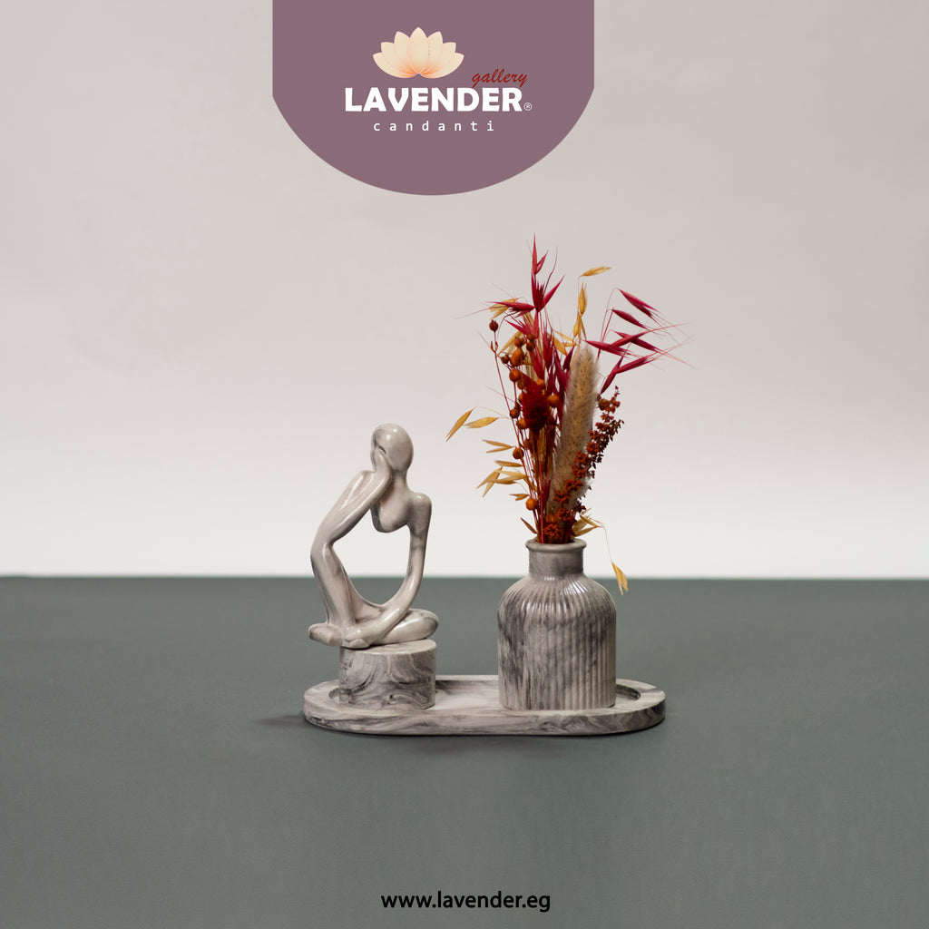 Decorative statue and vase with dried flowers 