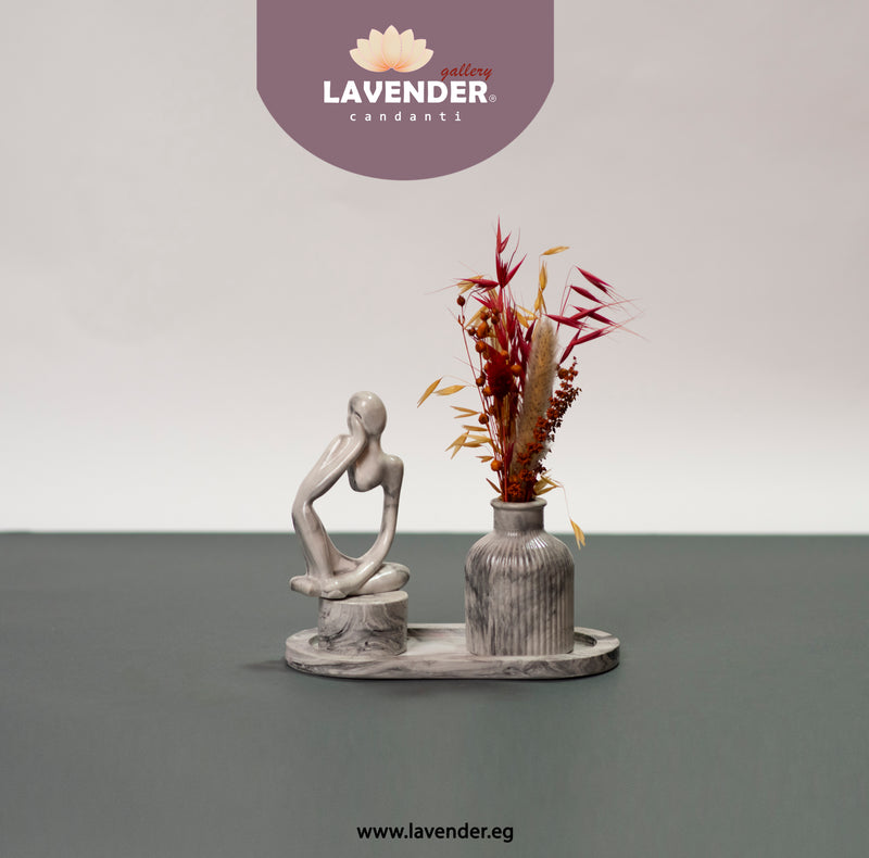 Decorative statue and vase with dried flowers 