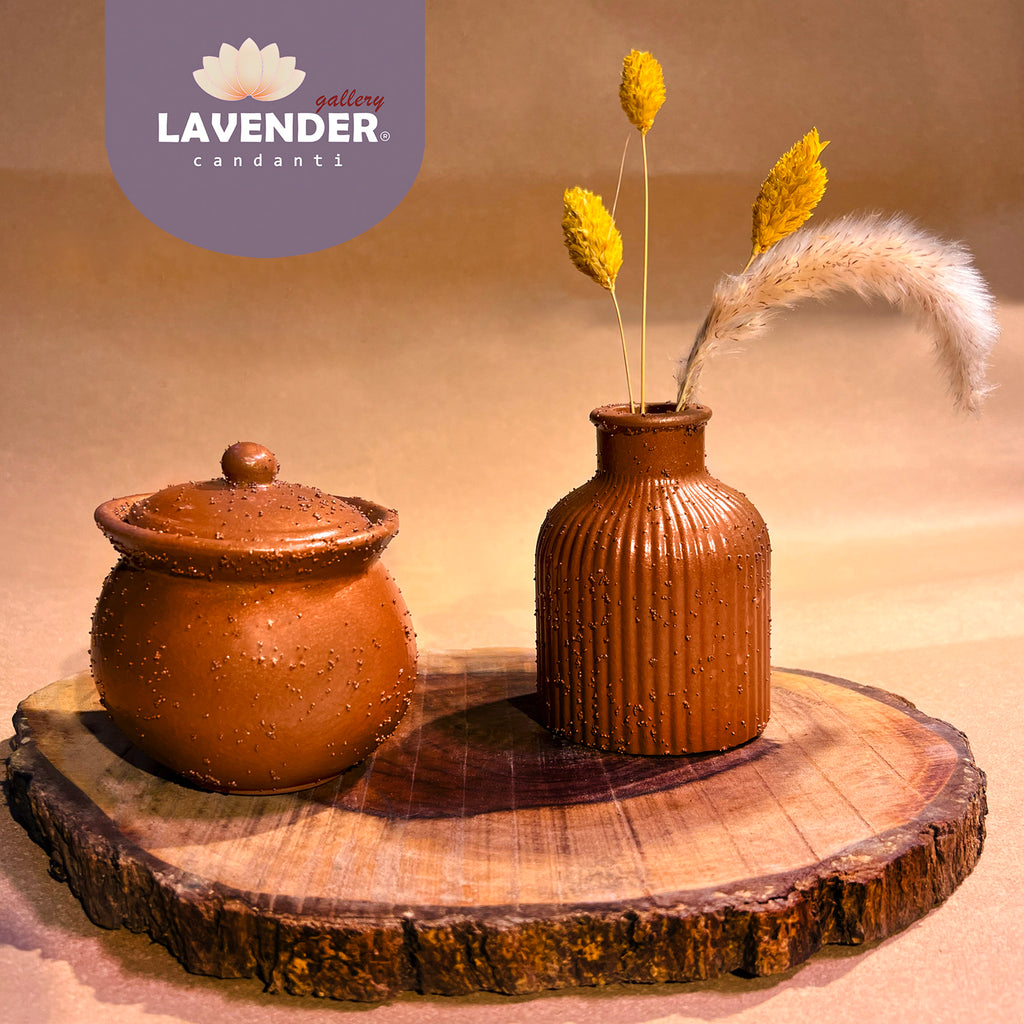 Two terracotta pots on a wooden surface with dried plants