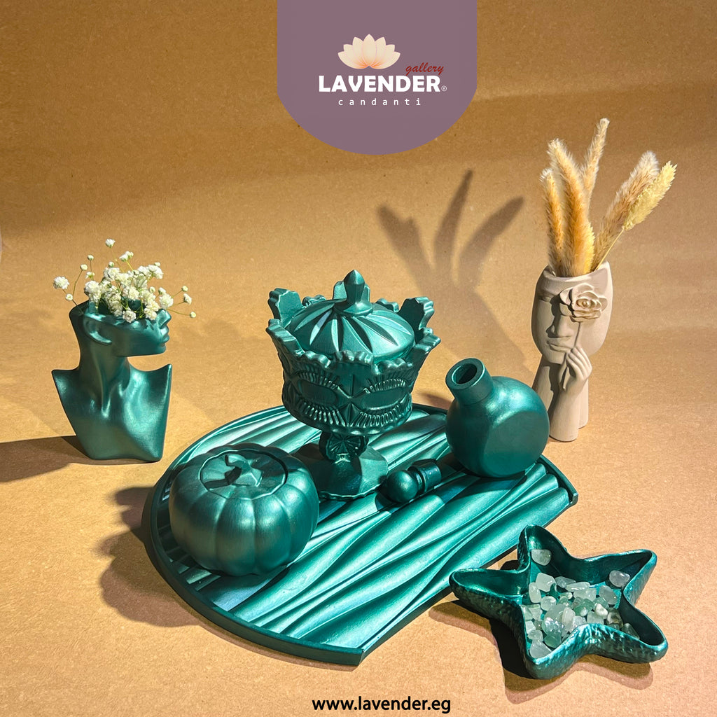 Collection of decorative items including a teal candle holder, star-shaped dish, and small vase with dried plants 