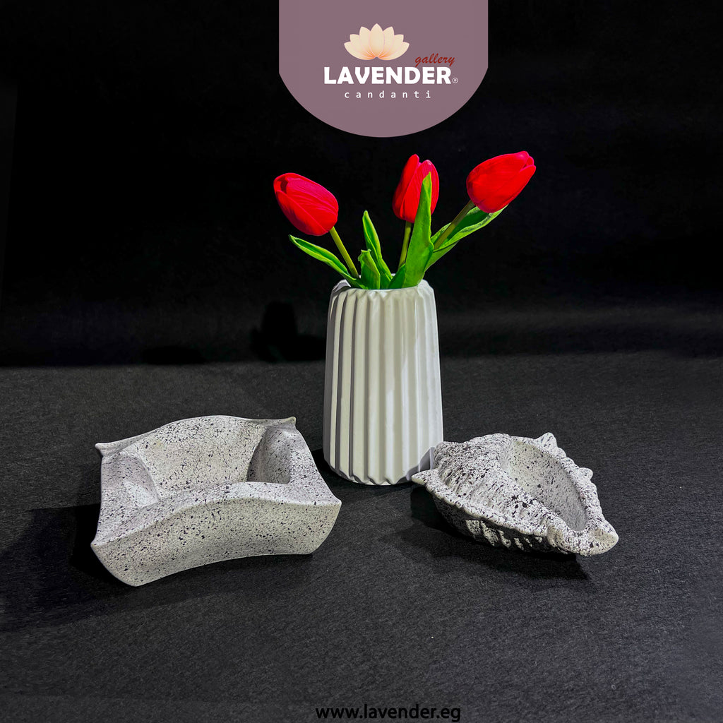 Decorative concrete pieces with a vase of red tulips 