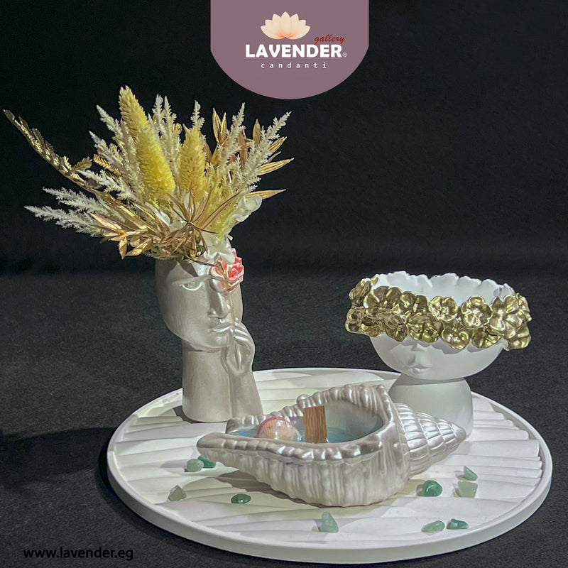 Decorative setting with a vase, shell, and bowl 