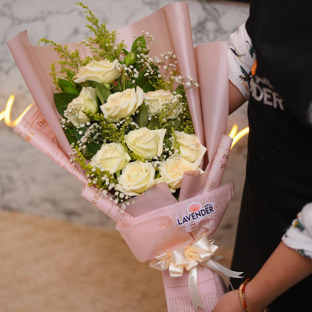 white roses. white gypsophila and green leaves