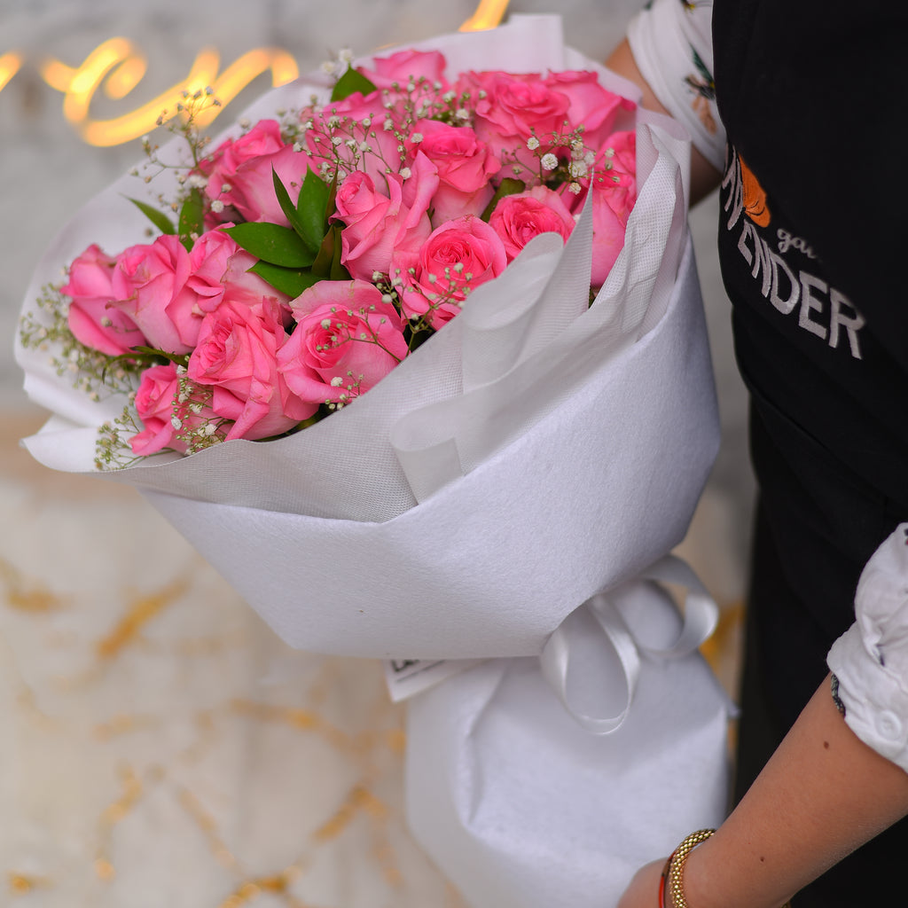 pink roses .hte gysophila and greeen leaves