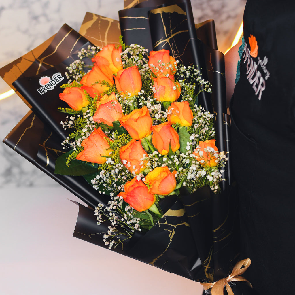 orange roses.whit gypsophila and green leaves