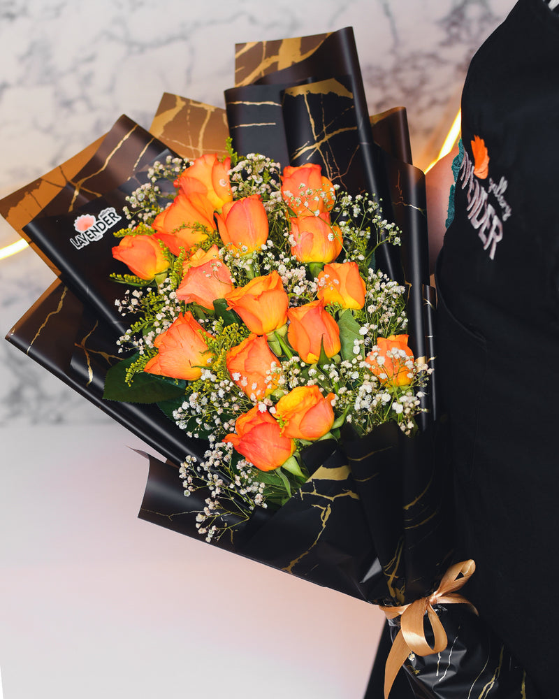 orange roses.whit gypsophila and green leaves
