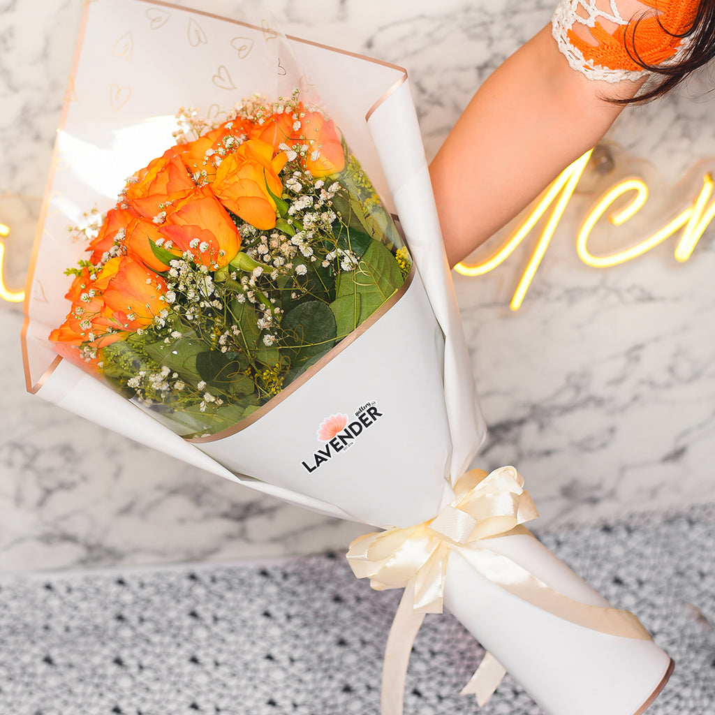 orange roses .white gypsophila and green leaves