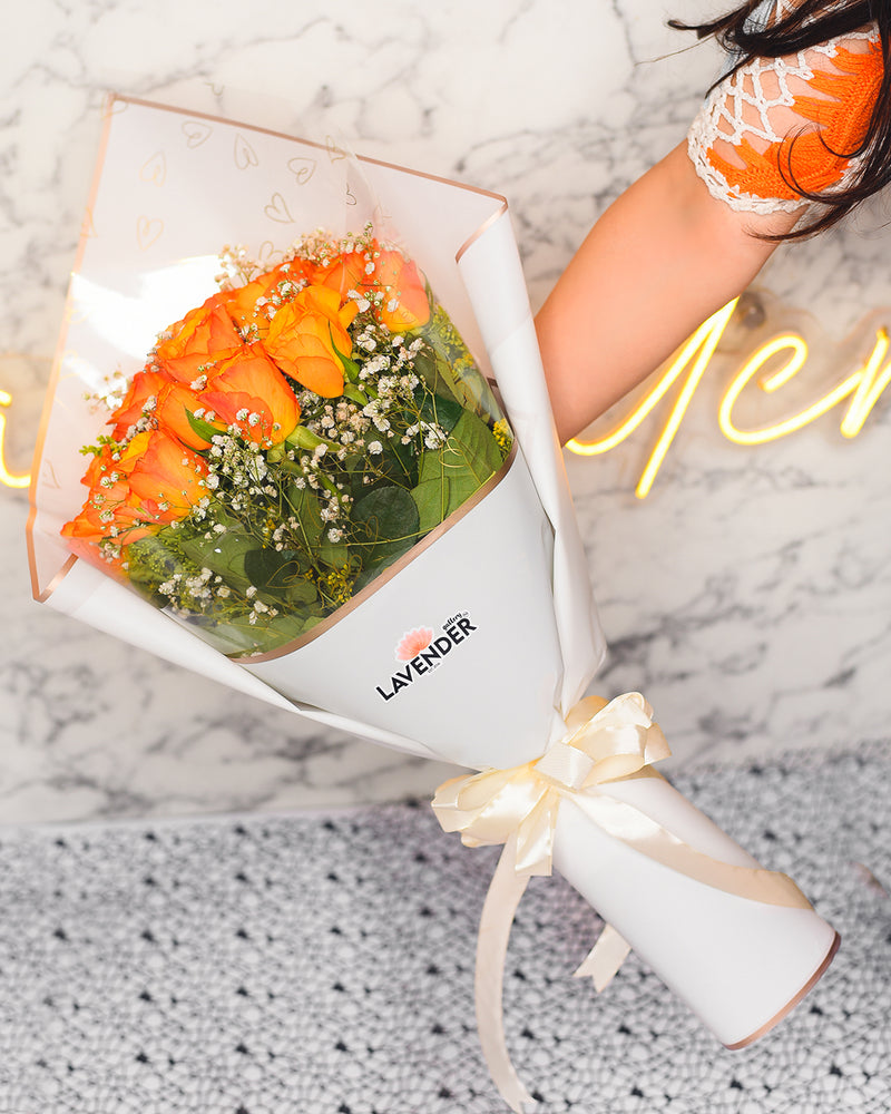 orange roses .white gypsophila and green leaves