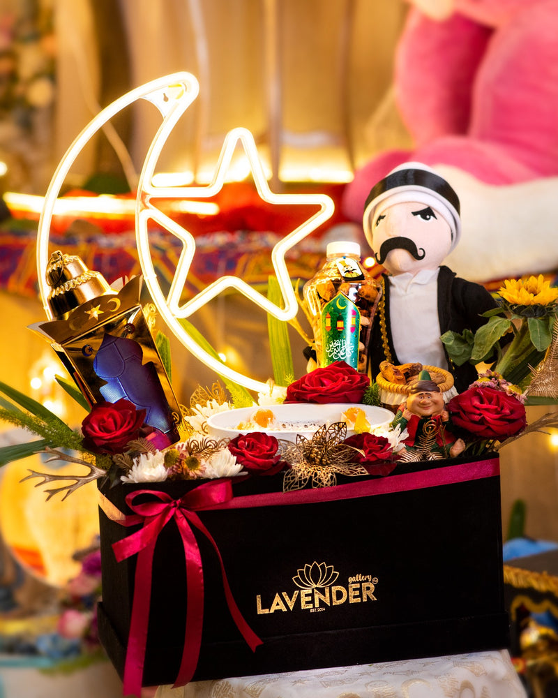 Decorative gift box with flowers, a star-shaped light, and a figurine on a colorful background.