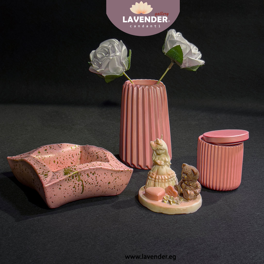 Set of pink ceramic items including a vase, bowl, and containers 