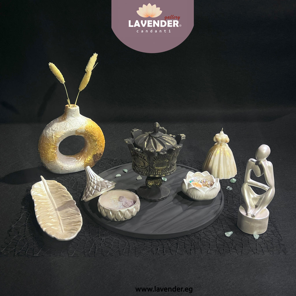 Decorative items including a vase, figurines, and a bowl on a dark surface 