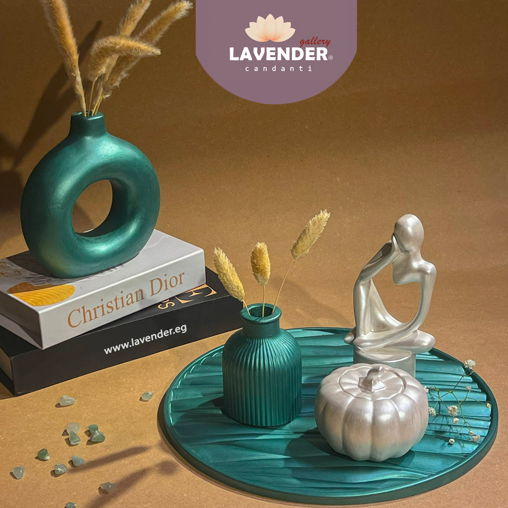 Decorative items including a teal vase, silver sculpture